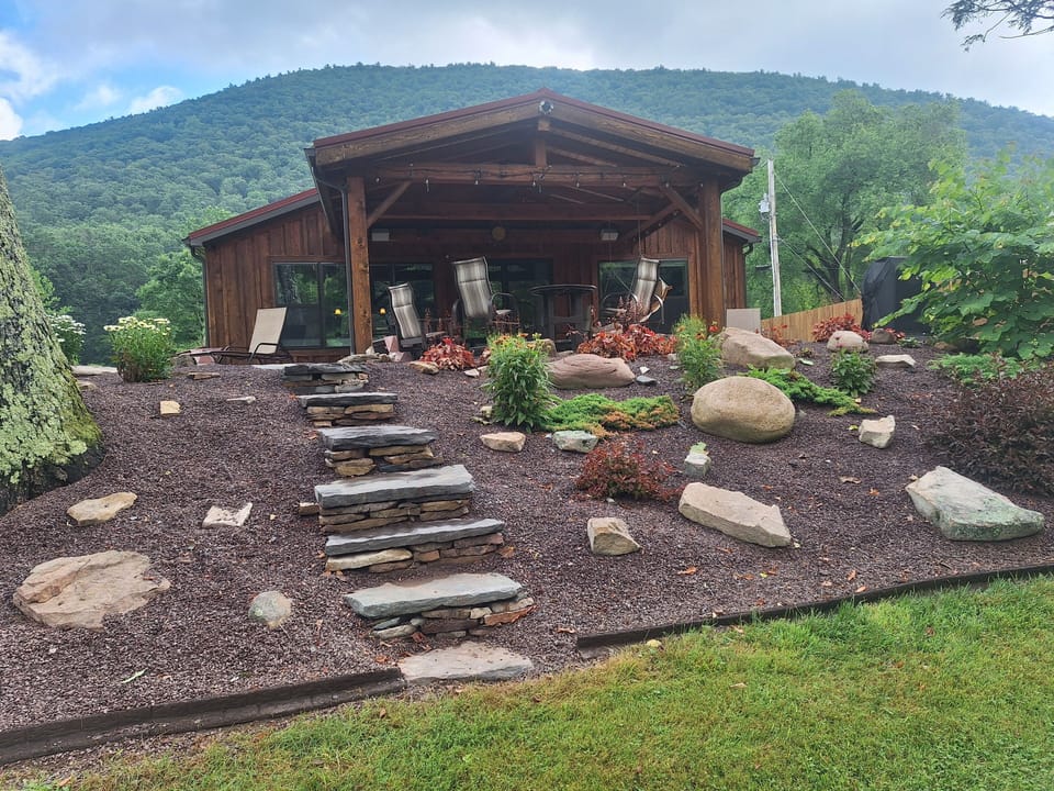 massive covered patio looking directly over Pine Creek