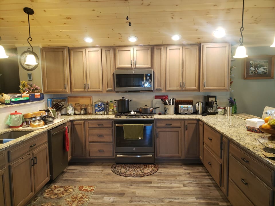 well lite  kitchen that is well supplied for cooking 