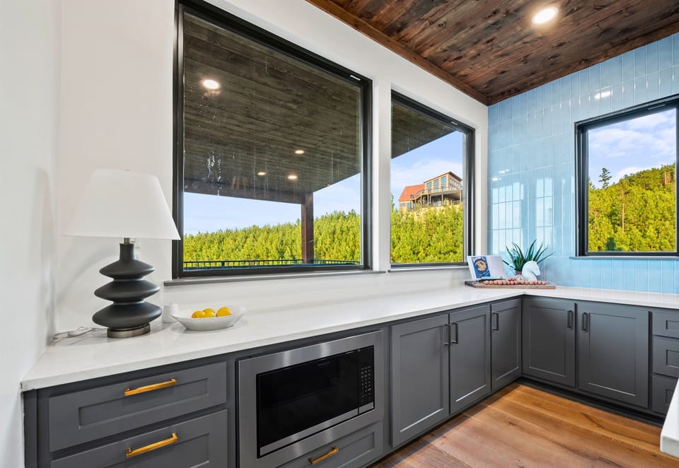 Bright and inviting, this kitchen corner with its stunning views is the perfect spot for your morning coffee or an evening glass of wine as you soak in the tranquility.