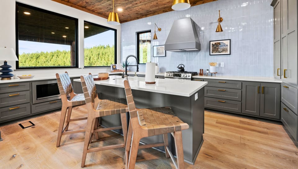 Let the outside in while you cook in our airy kitchen, framed by forest views. It's the perfect mix of modern amenities and natural serenity.