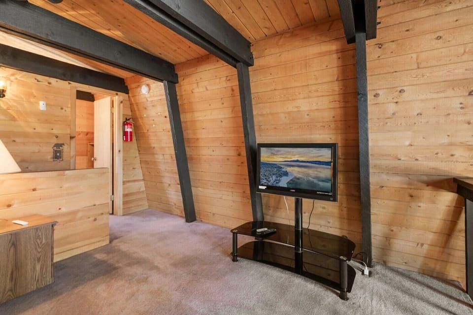 Upstairs loft space with sofa bed (sleeps 2) and TV