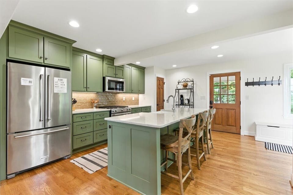 The center island offers functionality not just for extra workspace but also a spot for social gatherings and meals.