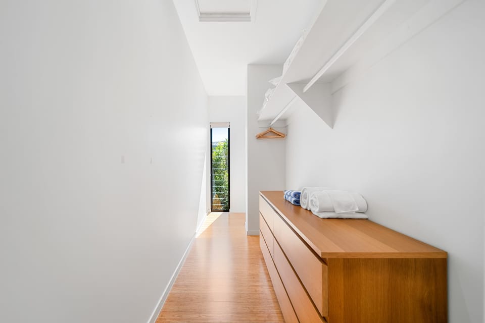 Enjoy the convenience of a spacious walk-in wardrobe, perfect for longer stays or keeping everything neatly organised during your coastal escape.