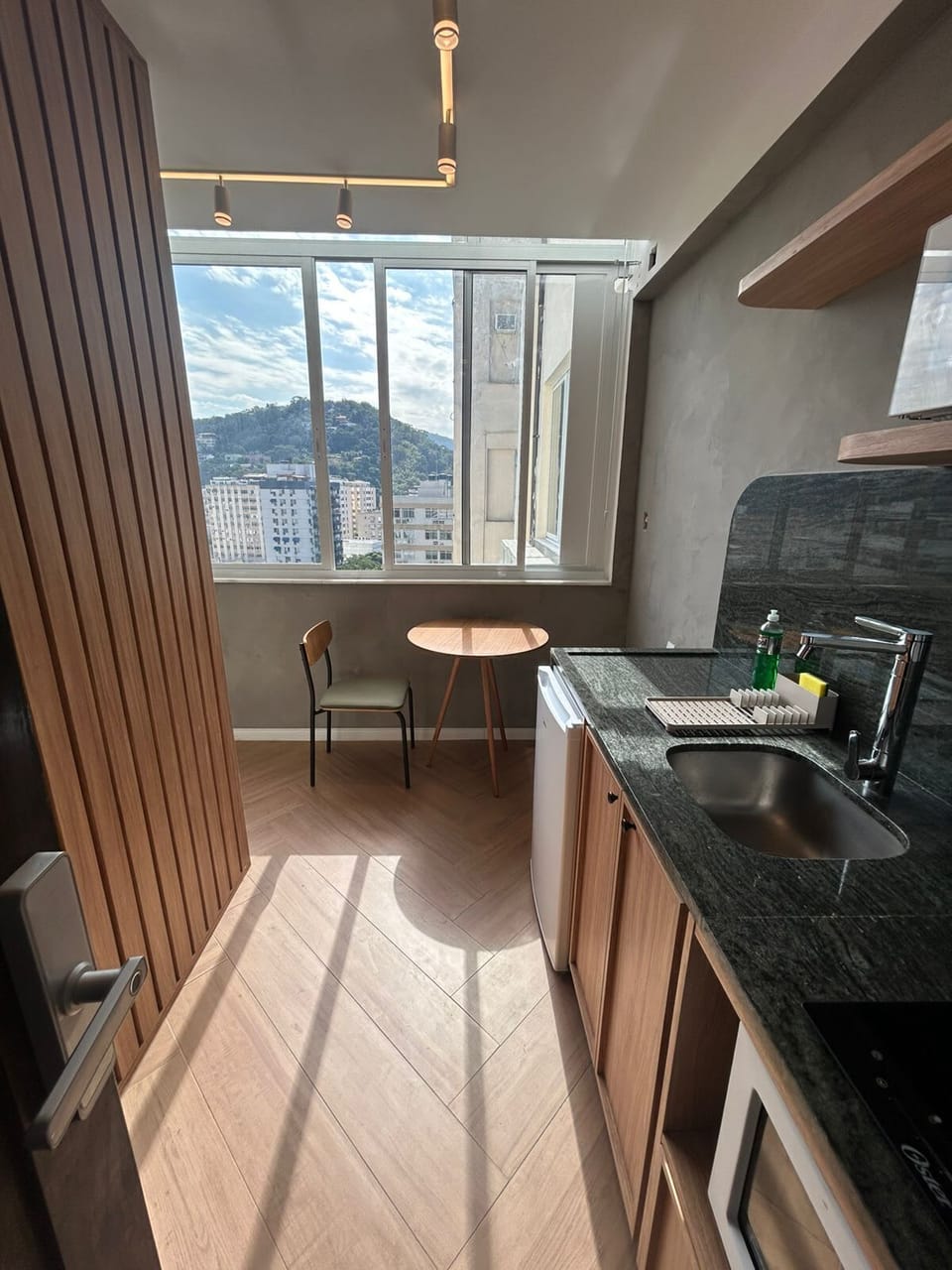 Entrance View. Kitchen fully stocked with cooking & eating utensils. The kitchen also includes a coffee maker & a full set of pots & pans. Table, chair and bench seat, dining for 2. Free view to Laranjeiras hillside.