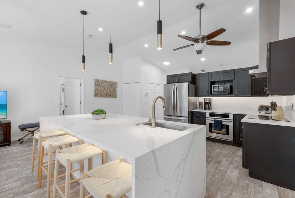 Bright, modern kitchen fully equipped with all the essentials—perfect for cooking and gathering during your stay.