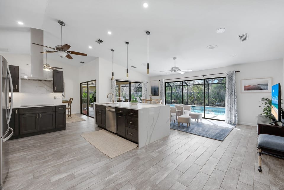 Fully updated kitchen and family room with fully opening sliding doors and a stunning pool view- ideal for vacation relaxation.uu