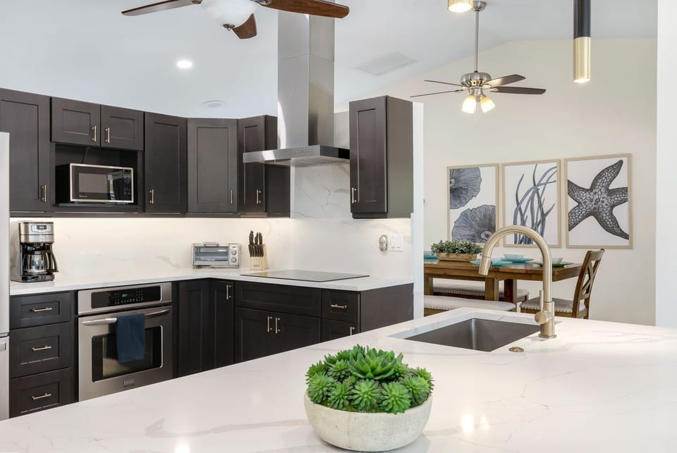 Sleek and fully equipped kitchen with modern appliances and coastal accents — perfect for cooking at home in style.