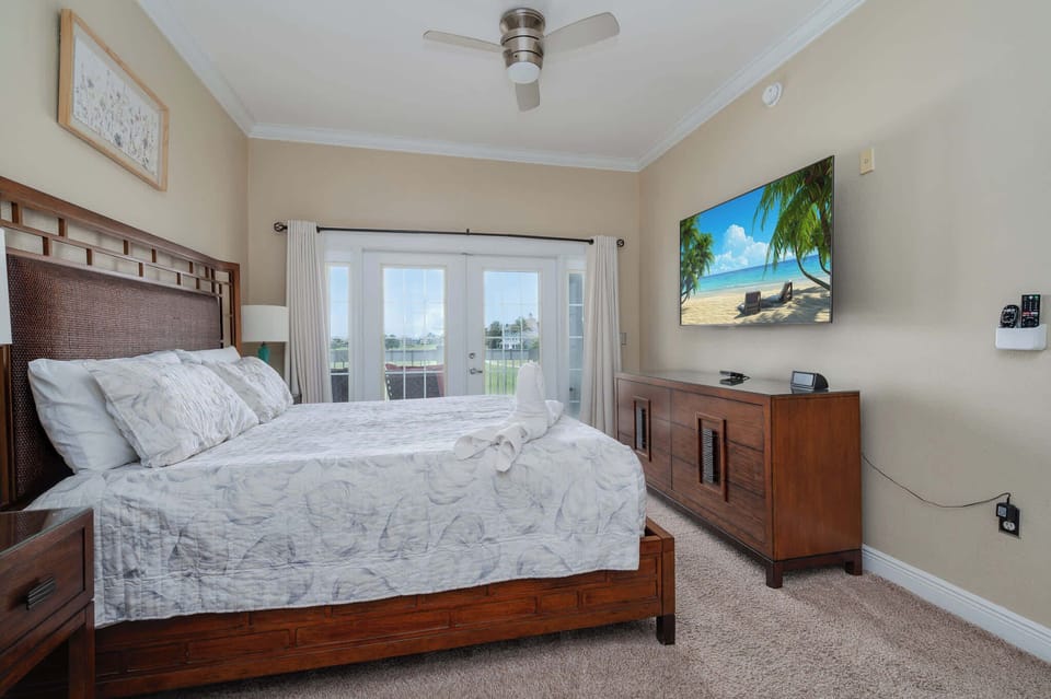 Your serene master retreat awaits, complete with a comfortable bed and direct balcony access to enjoy the beautiful surroundings.