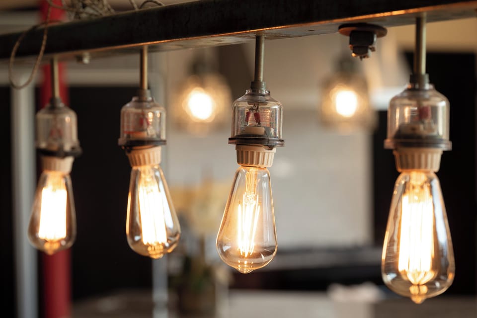 Warm Edison bulbs cast a cozy glow, creating the perfect ambiance for your evening conversations and memorable moments together.
