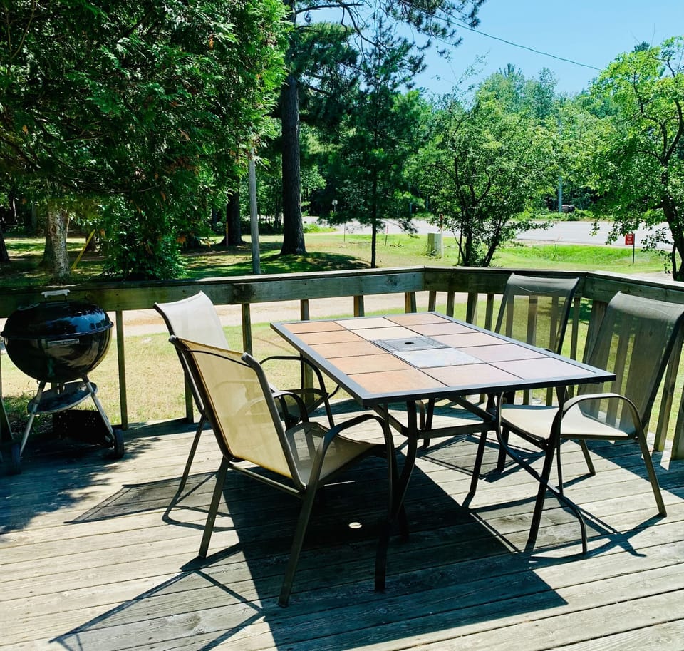 View of the deck from the kitchen - with grill and patio set.
