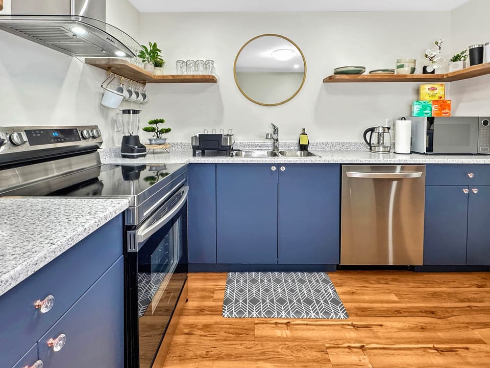 Modern Blue Kitchen with Stainless-Steel Appliances and Open Shelving