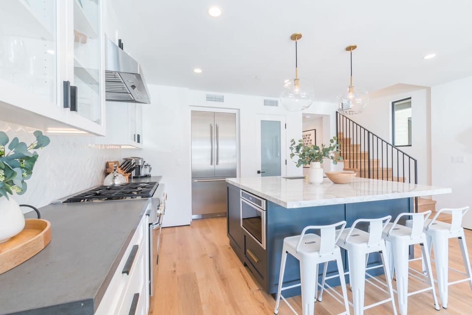 Gather around the kitchen island while meals are prepared in this spacious kitchen
                