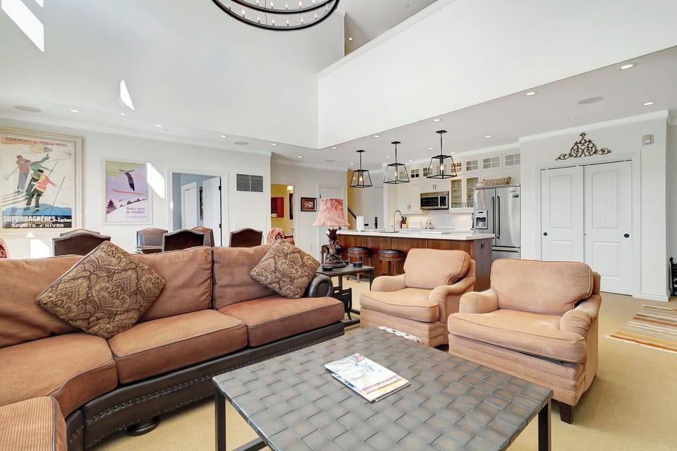 - Spacious open-concept living area with cozy seating   - High ceilings and warm tones for a mountain escape   - Perfect gathering spot after skiing or exploring