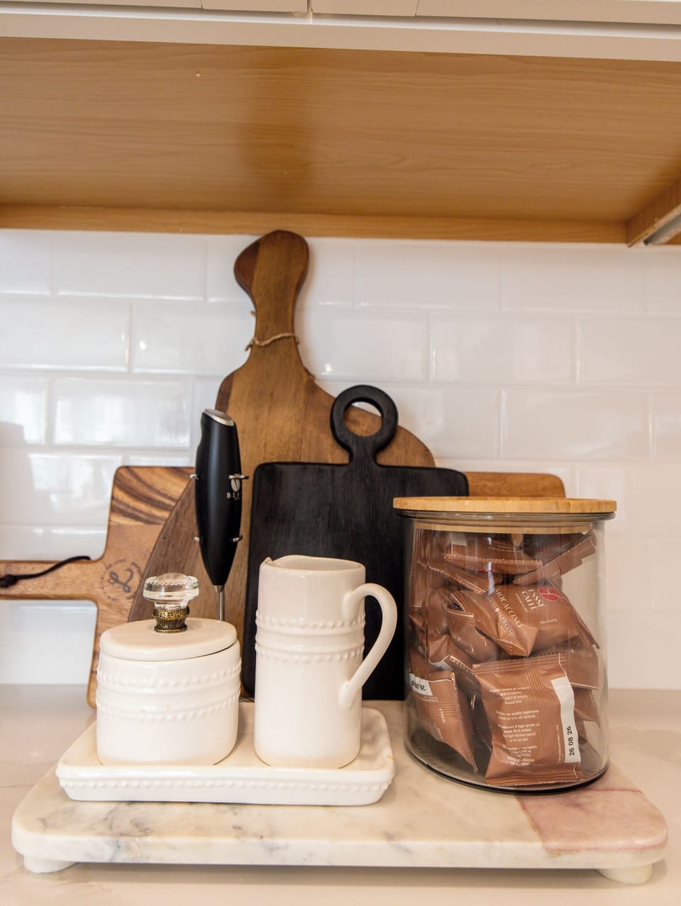 Chic coffee nook with frother, mugs & pods for your morning brew