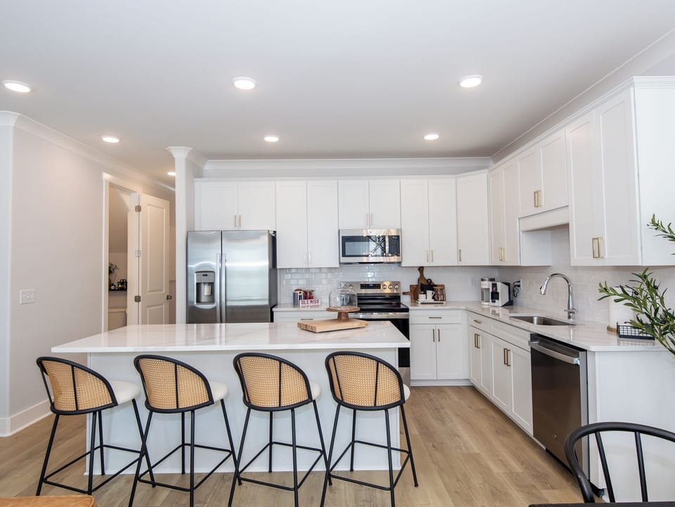 Spacious gourmet kitchen with island seating for 5 and ample storage

