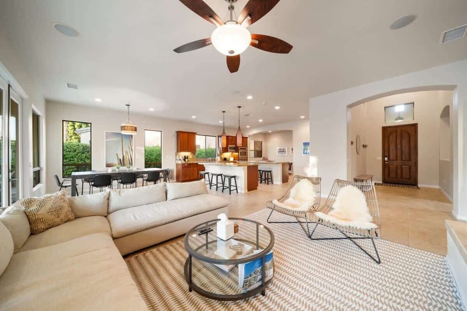 Comfort meets connection — from the cozy sectional to the open kitchen and dining space, it all flows naturally.