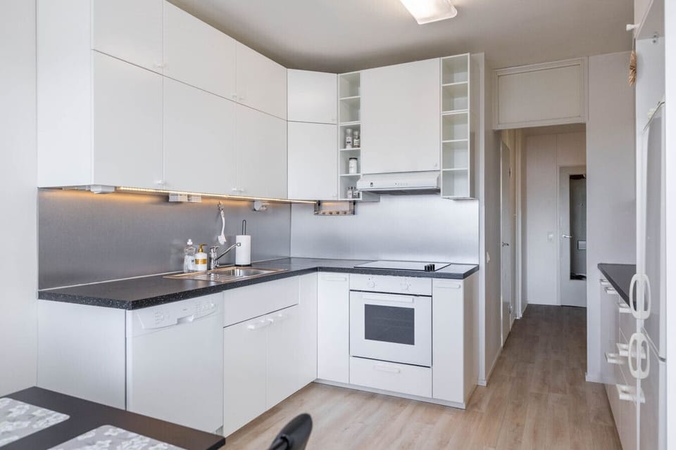 Modern and functional kitchen with a predominantly white and grey color scheme.