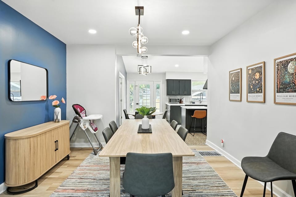 Modern dining room with seating for 8, designer lighting, and direct flow into the stylish kitchen—perfect for shared meals and conversation.