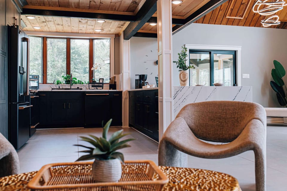 From breakfast to happy hour, this open-concept space is designed to flow with your day. Vaulted wood ceilings, custom cabinetry, and curated décor offer refined comfort and style at every turn.