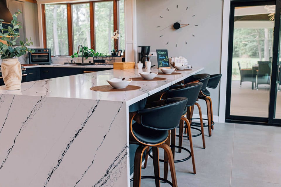 Sleek and inviting—this waterfall island is the heart of the home. 
