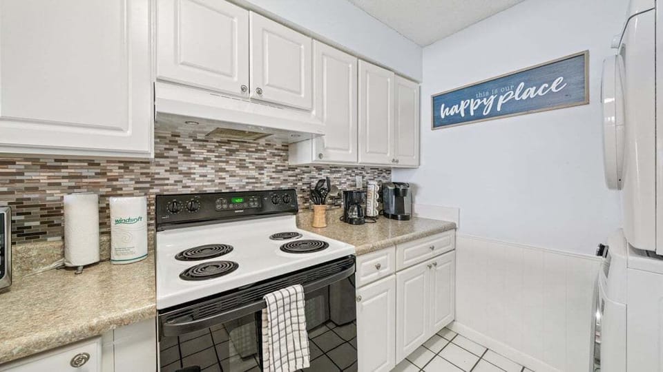 Bright kitchen with full-size appliances, coffee station, and cozy beach vibe—your happy place to cook and relax.