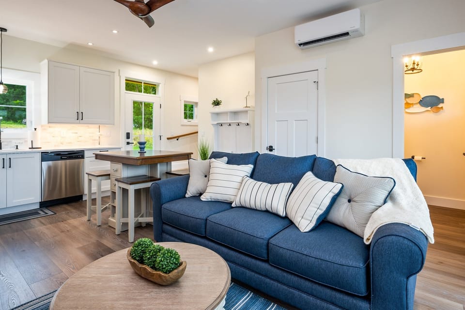 Relax in the stylish living space with plush seating and direct access to the outdoors—perfect for family gatherings.