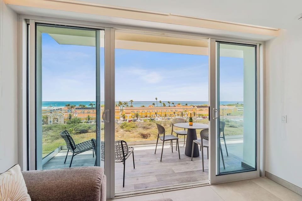 Step through sliding doors onto your private balcony, where ocean views and coastal breezes meet your morning coffee or sunset glass of wine at your personal outdoor dining table.