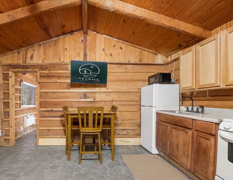 Charming hotel room kitchen with a rustic wood interior and cozy, homey touches.