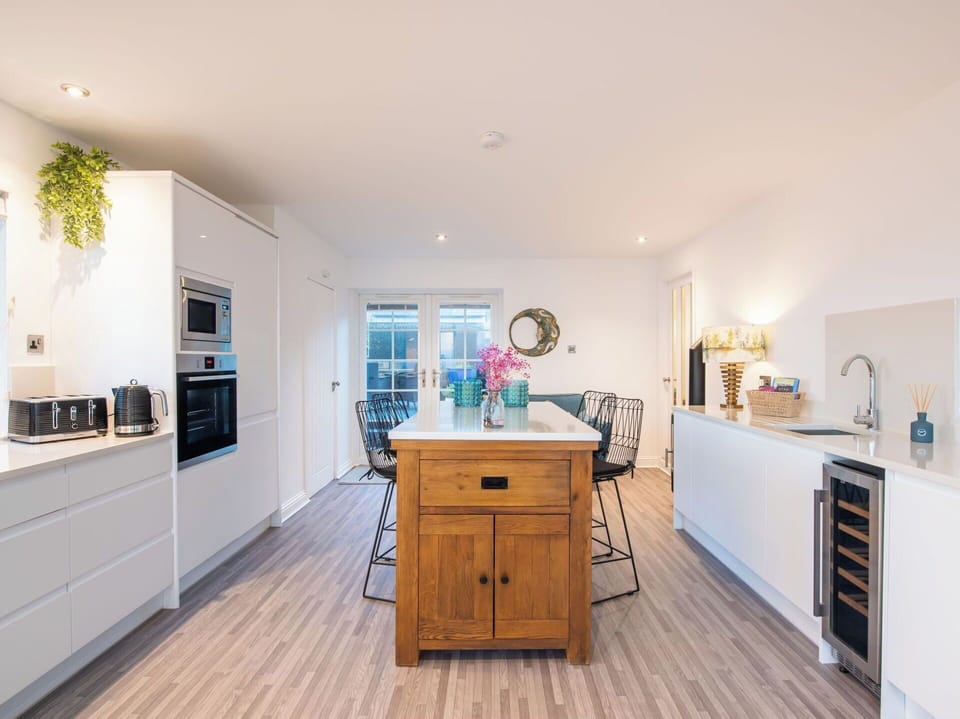 Furniture, Interior Design, Flooring, Countertop, Kitchen, Cabinetry, Floor, Kitchen Appliance, Wood Flooring, Wood