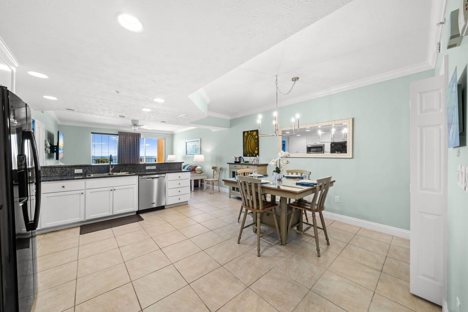 Open kitchen and dining area with modern appliances and coastal views.