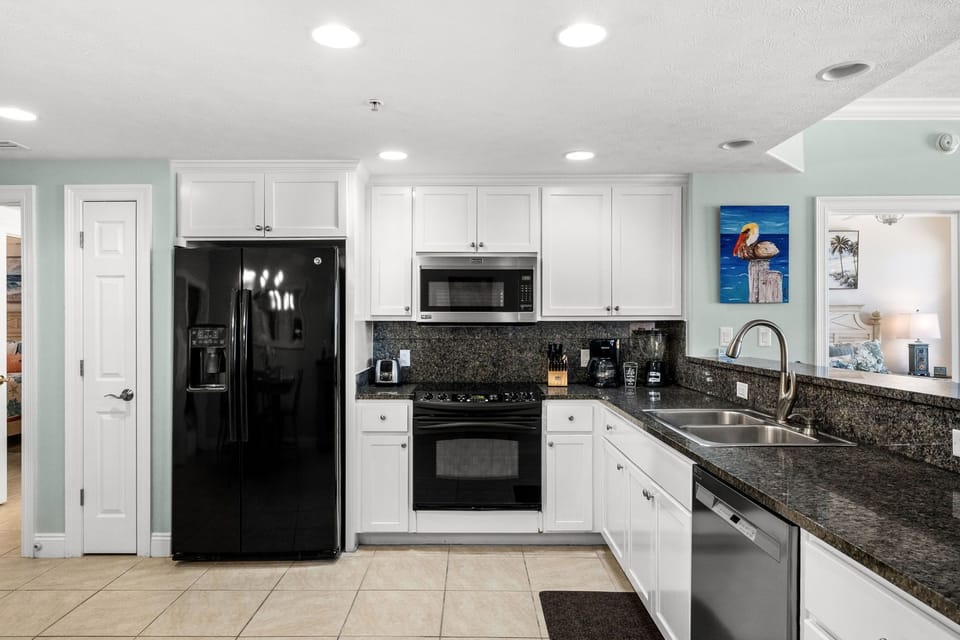 Modern kitchen with black appliances and granite countertops