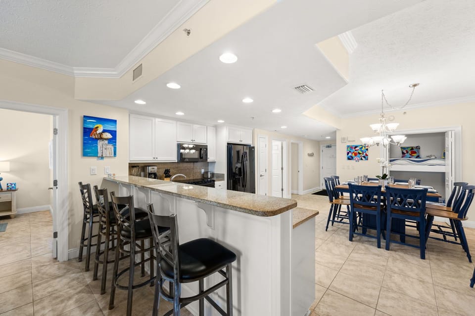 Bright, open-concept kitchen & dining space w/ recessed lighting & elegant granite countertops.