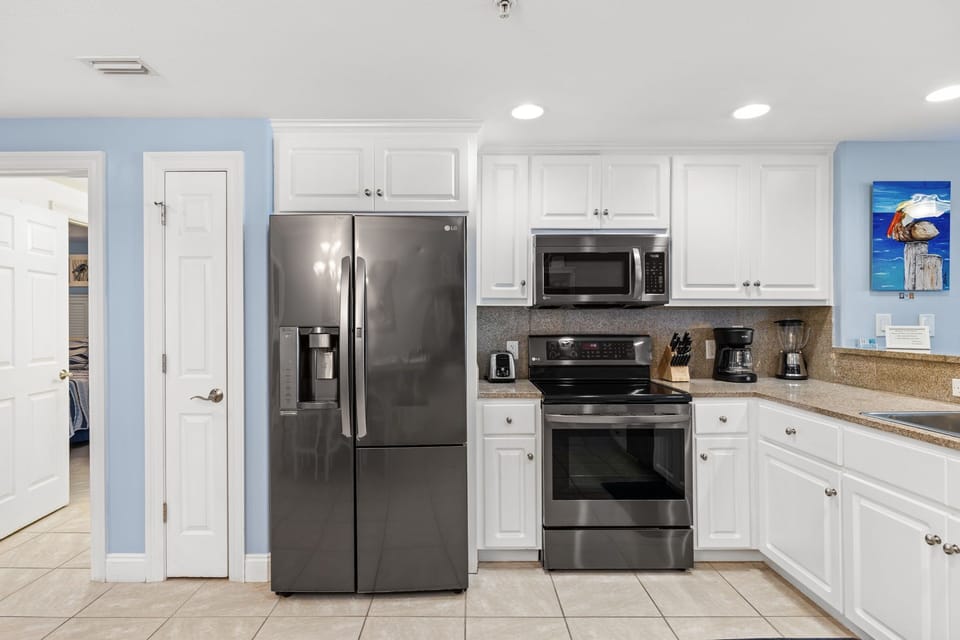 Modern kitchen with stainless steel appliances and white cabinetry