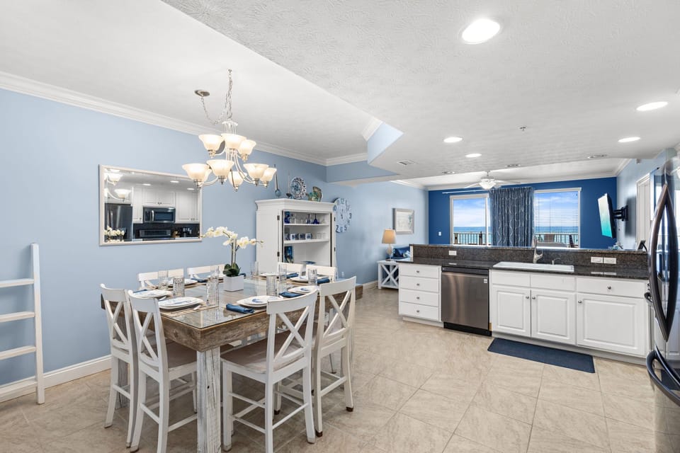 Open dining and kitchen area with ocean views and modern coastal decor