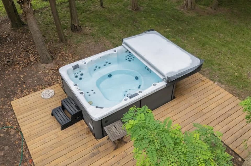 Let the jets melt your stress in a forest-framed spa.