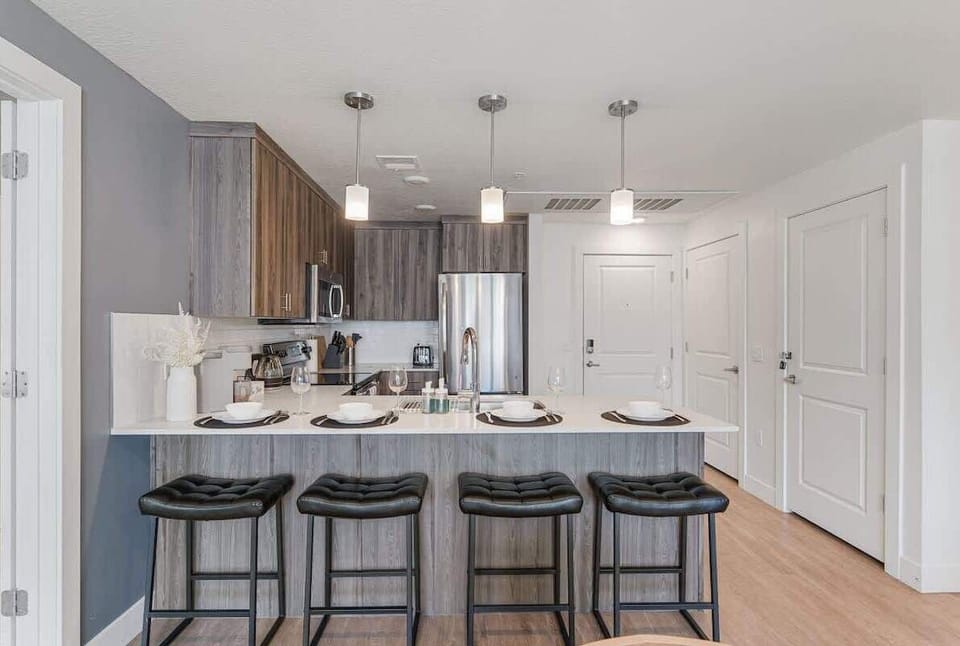 Cook up a storm in our well-appointed kitchen, featuring an induction stove, oven, and plenty of seating at the island.