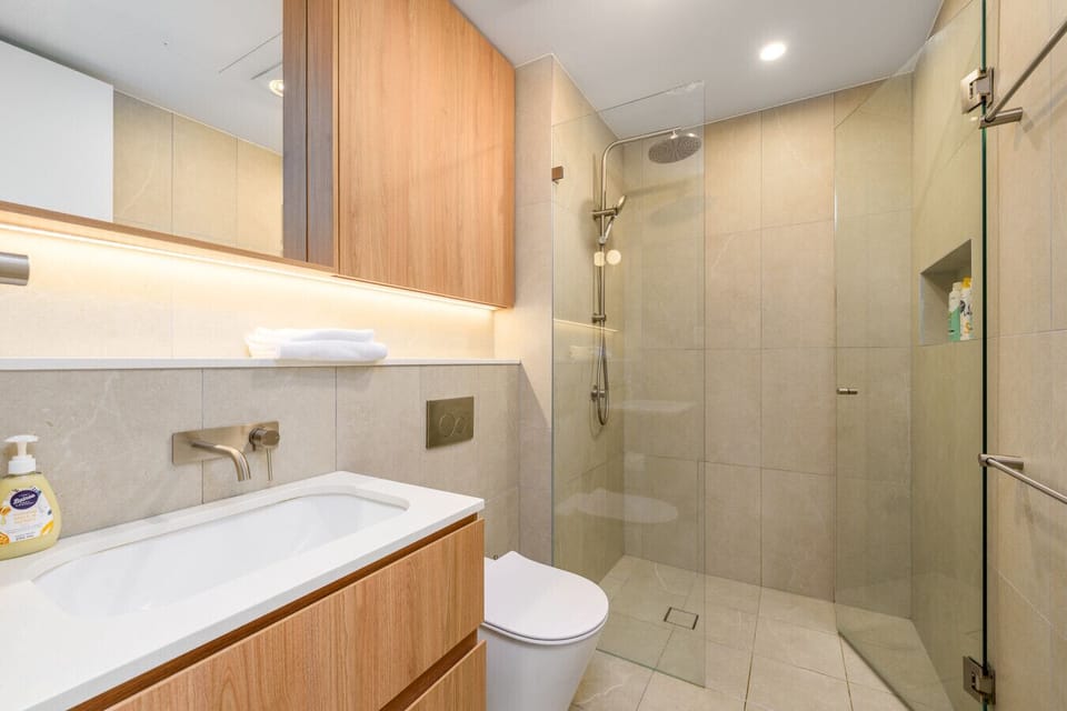 Refresh in a sleek, spa-inspired bathroom where clean lines and calming tones invite you to unwind.