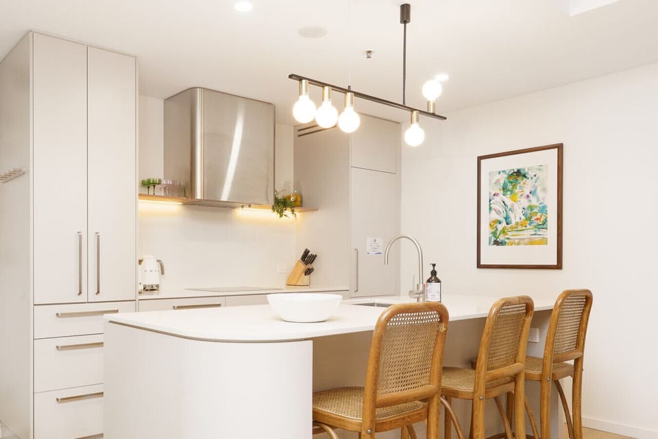 Cook, gather, and graze in a bright, functional kitchen with modern appliances and inviting dining space.