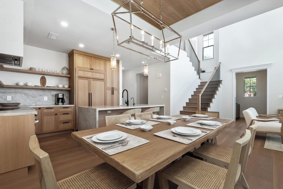 Your open-concept kitchen and dining area blends modern elegance with warm wood finishes, perfect for memorable meals together.