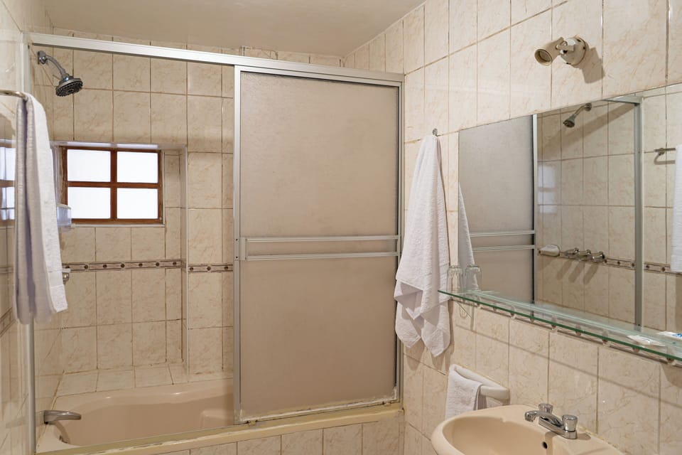Standard Triple Room, Balcony, Courtyard View | Bathroom | Shower, towels, soap, shampoo