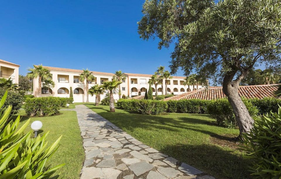 Stroll peaceful stone pathways surrounded by greenery—just a 4-minute walk to the beach.