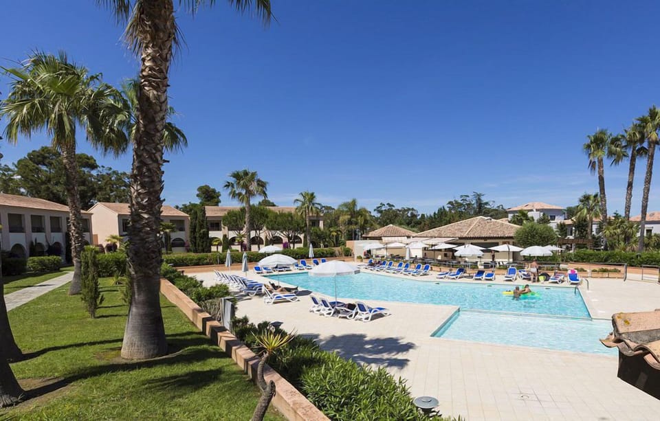 Sunbathe or unwind by the spacious main pool, perfectly placed for summer days in Linguizzetta.