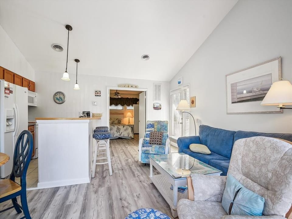 With its layout connecting the living room and kitchen, this cozy space offers a functional yet stylish design perfect for both relaxation and entertaining.