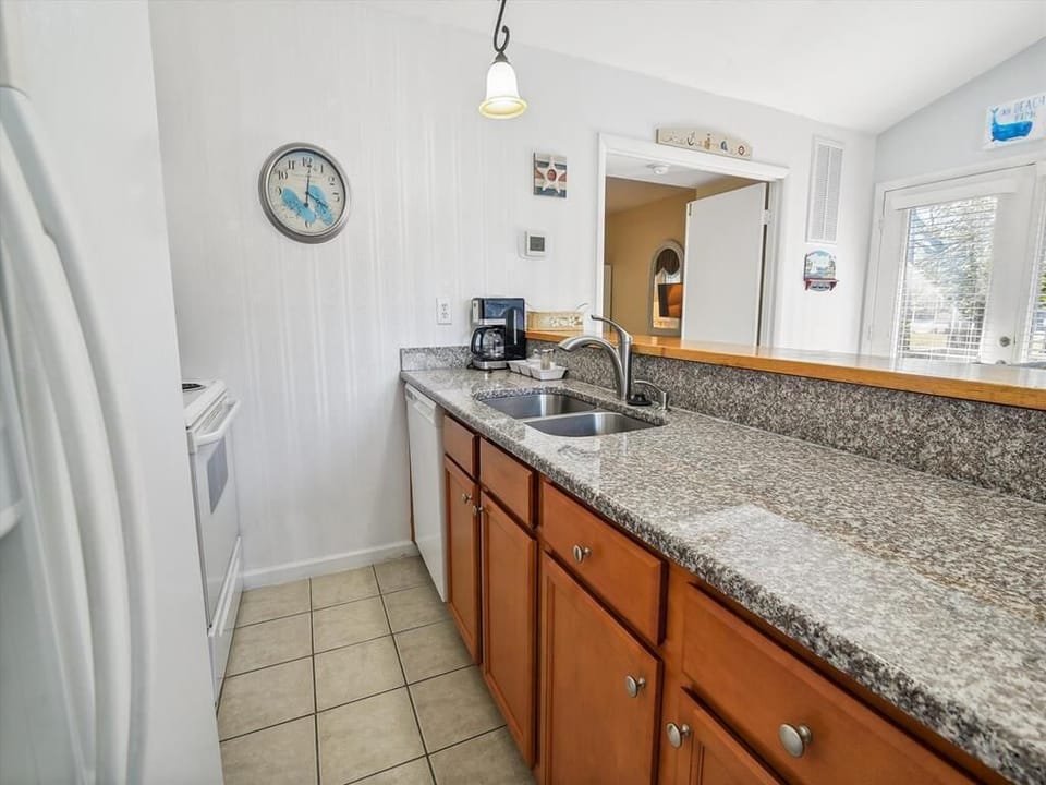 Extended granite countertop ideal for meal prep, with in-suite laundry tucked neatly nearby.