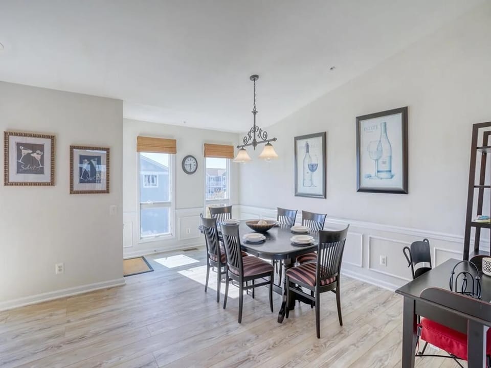 Inside, the dining area features elegant furnishings, natural light flowing through ample windows, and tasteful decor that evokes a coastal chic aesthetic.