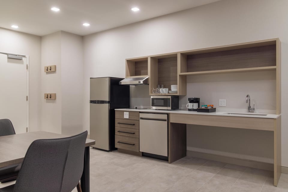 Suite, 1 King Bed with Sofa bed (Roll-In Shower) | Private kitchen | Full-size fridge, microwave, stovetop, dishwasher