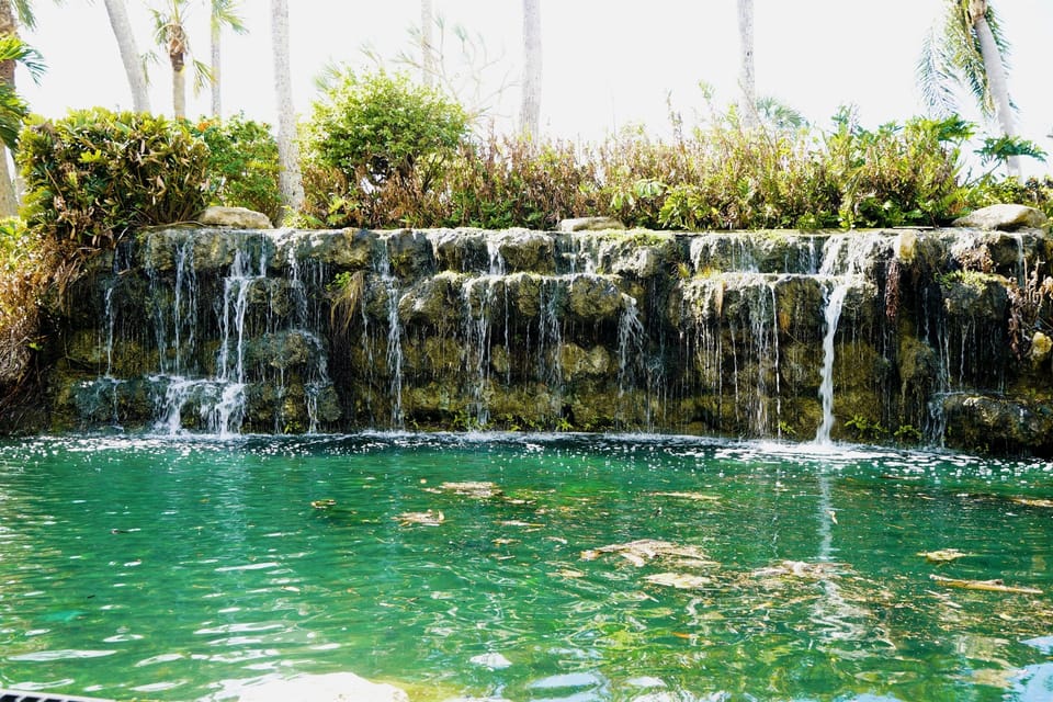 Tranquil waterfall feature brings peaceful vibes to your vacation backdrop.