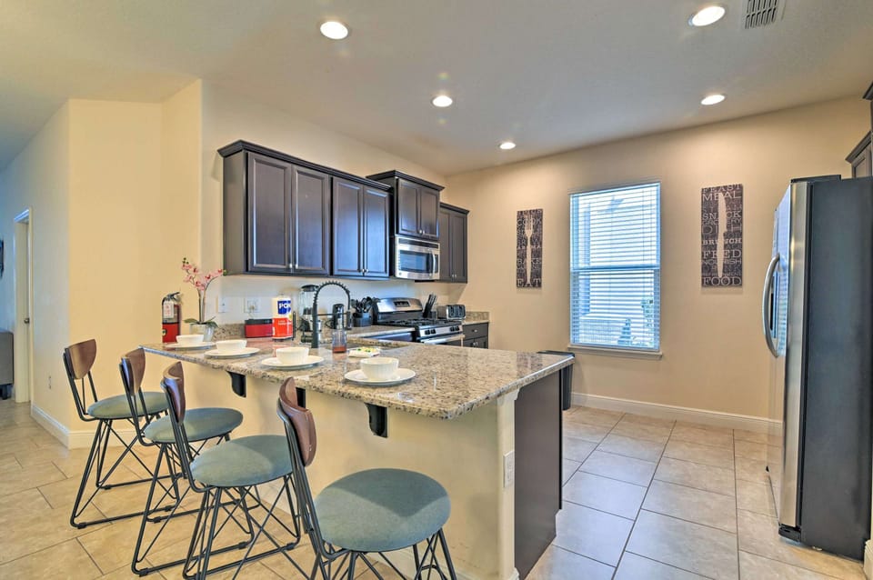 Modern kitchen with granite countertops and a breakfast bar for casual dining.