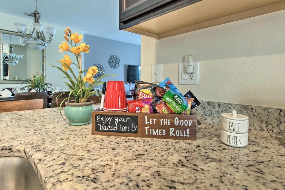 Granite kitchen countertop with a snack basket and decorative flowers.