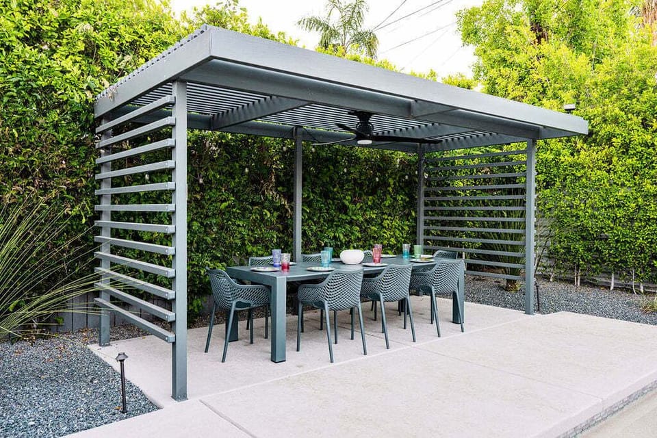 Gather for outdoor meals beneath the shaded pergola, perfect for entertaining day or night.